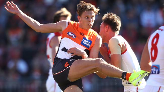 Lachie Whitfield kicks under pressure during last year’s clash with Sydney at Giants Stadium. Picture: Phil Hillyard