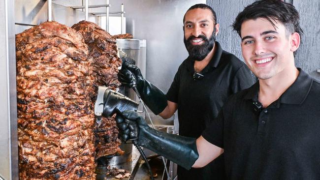 George Fournaros and Takhat Gill prepare a yiros at The Yiros King in Reynella. Picture: Brenton Edwards