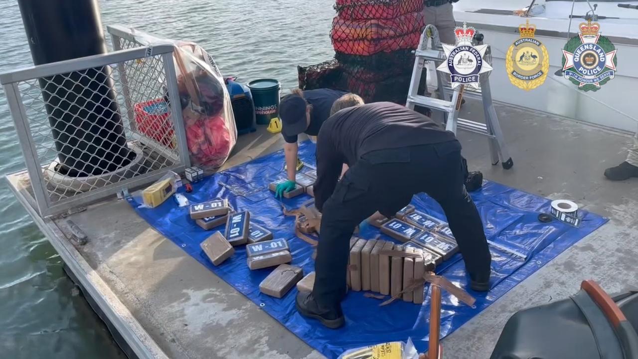 Police go through items found on the boat at Hervey Bay.