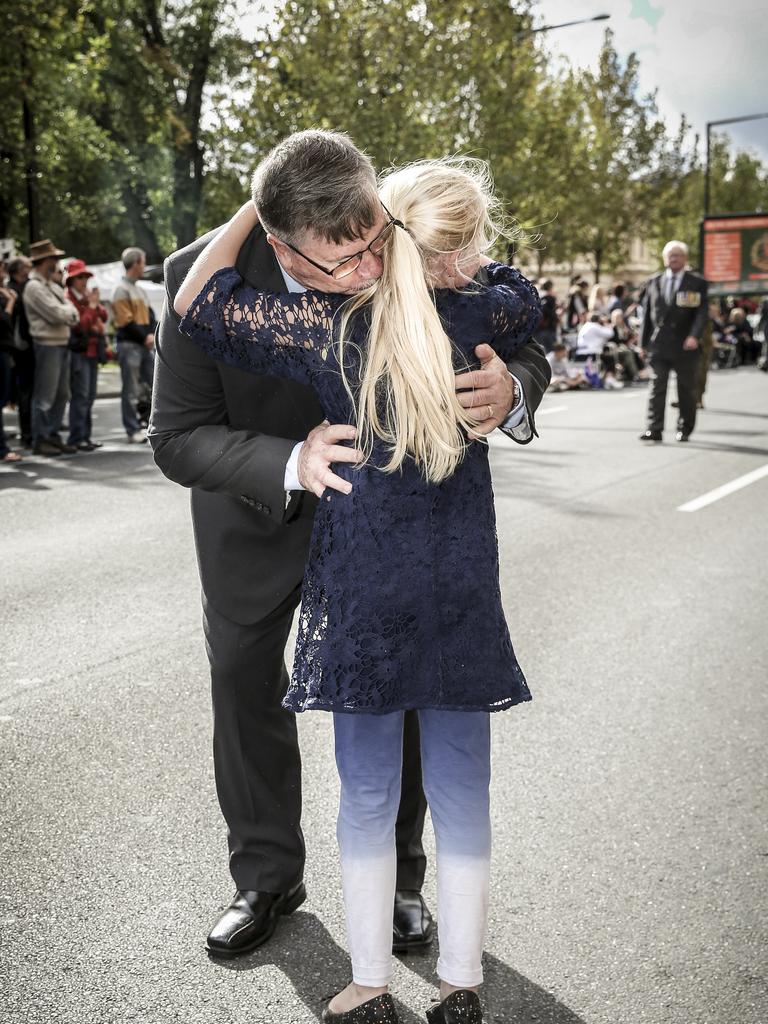 Sophie, 9, runs out to hug her grandpa, Tim, who served with the SAS. Picture: Mike Burton