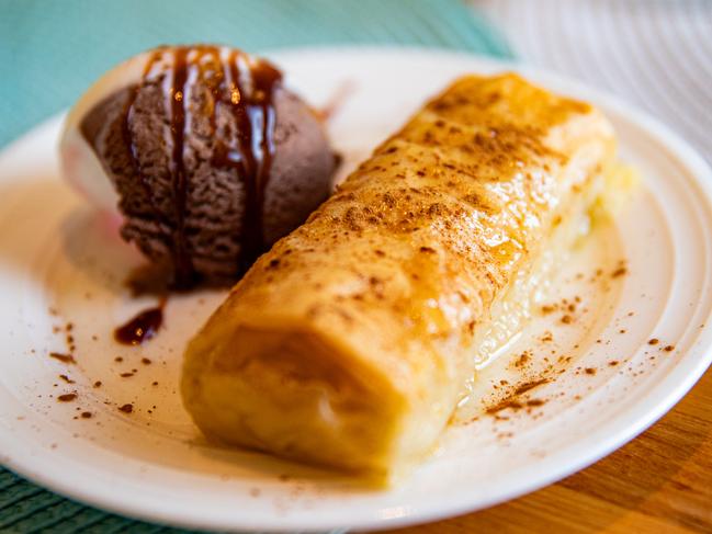 Filoxenia’s traditional Greek dessert, Galaktoboureko, served with Neapolitan ice cream and a drizzle of chocolate sauce. Picture: Linda Higginson