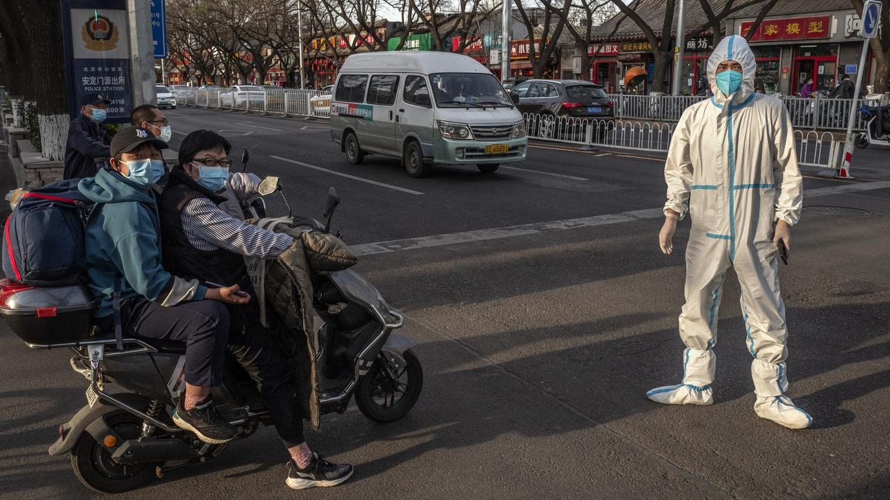 A health worker waits to do a routine patient transfer during evening rush hour on April 12 in Beijing, China. Picture: Kevin Frayer/Getty Images