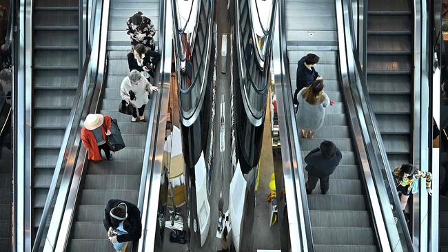 Shoppers on escalators in Sydney. Picture: AFP