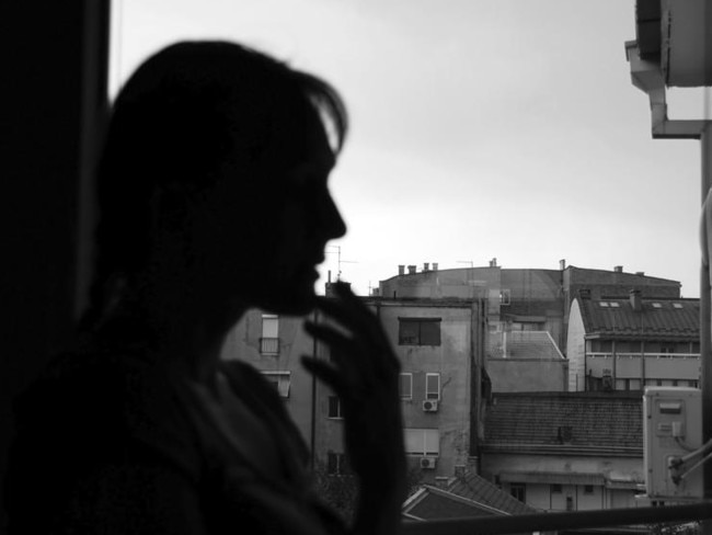 Female silhouette by window