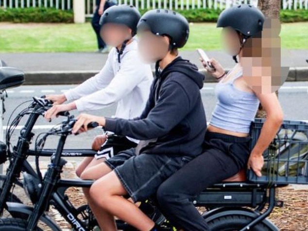 Young people on e-bikes at Manly.