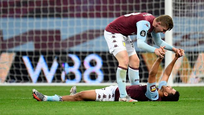 Matt Targett celebrates with the goalscorer. Picture: AFP