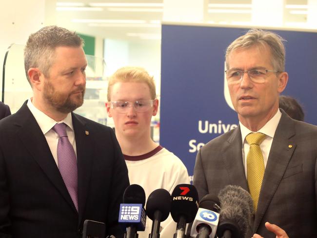 ADELAIDE, AUSTRALIA - NewsWire Photos July 3, 2023: SA Premier Peter Malinauskas, University of Adelaide Vice Chancellor, Prof Peter Hoj AC (R) & University of SA Vice Chancellor Prof David Lloyd visit Uni SA's Bradley Lab to hold a press conference regarding the proposed merger of the two universities. (Adelaide Uni student Caleb Lill in background) Picture: NCA NewsWire / Dean Martin