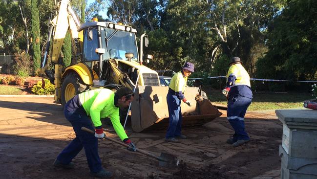 Workers clean up silt and mud from Willow Drive. Picture: Doug Robertson