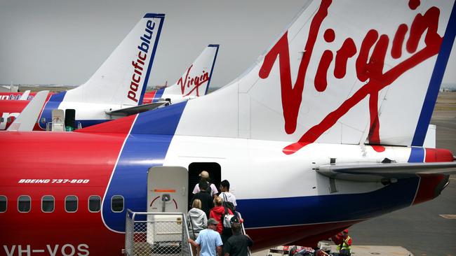 Passengers board a Virgin Australia plane.