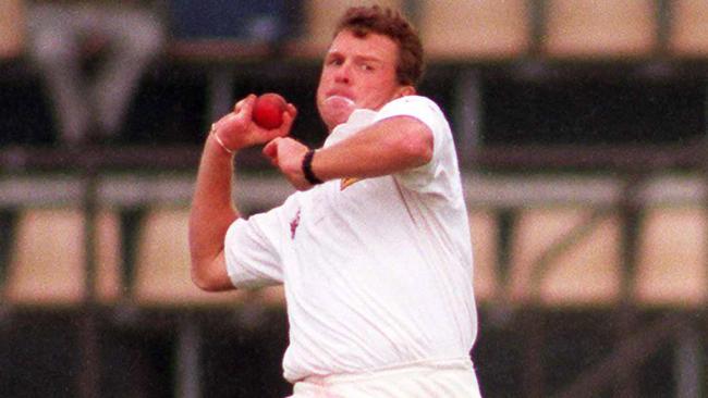 Craig McDermott bowling for Queensland.