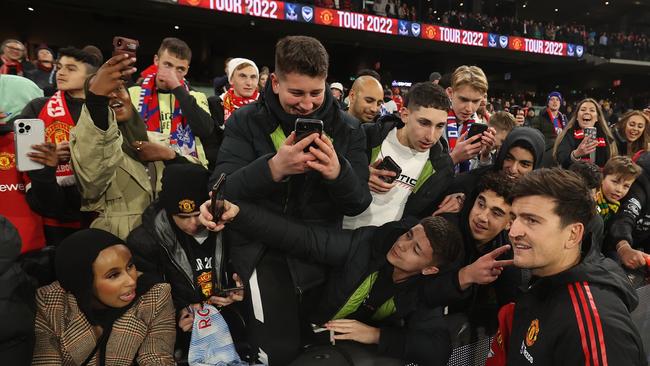 MELBOURNE, AUSTRALIA - JULY 19: Harry Maguire of Manchester United signs autographs after the Pre-Season Friendly match between Manchester United and Crystal Palace at Melbourne Cricket Ground on July 19, 2022 in Melbourne, Australia. (Photo by Robert Cianflone/Getty Images)