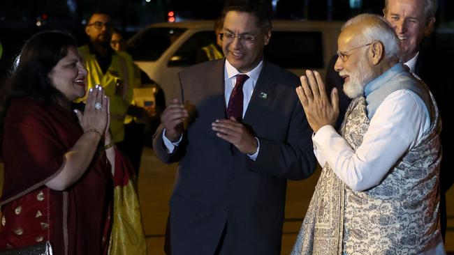 Indian diplomats greet India's Prime Minister Narendra Modi as he arrives at the Sydney international airport to begin his three-day official visit to Australia. Picture: David Gray/AFP