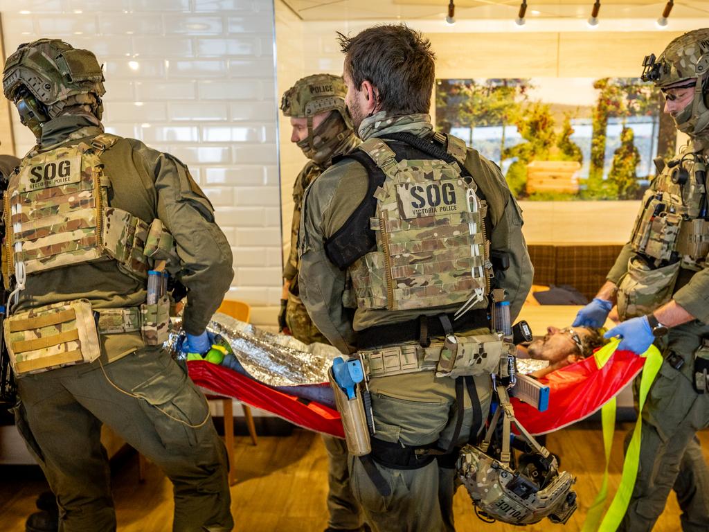 SOG personnel transport wounded passengers on makeshift stretcher beds. Picture: Jake Nowakowski