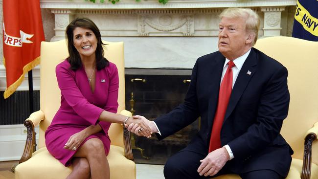 Donald Trump shakes hands with Nikki Haley in the Oval office of the White House in 2018.