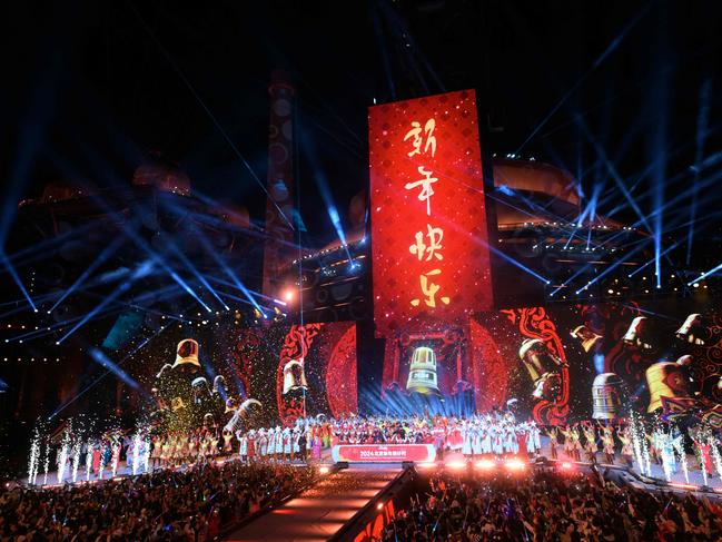 Glitter cannons and pyrotechnics erupt as revelers celebrate the New Year during a countdown event in Beijing, on December 31, 2023. Picture: Pedro Pardo / AFP