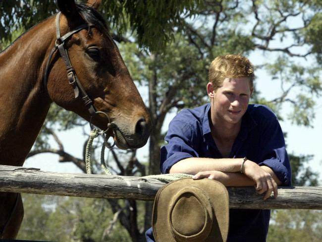 Prince Harry with horse Guardsman while working as a jackaroo at Tooloombilla Station in central outback Queensland, November 2003. Picture: Annette Dew