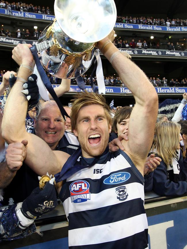 Tom Lonergan enjoys the spoils of Geelong’s premiership win in 2011. 