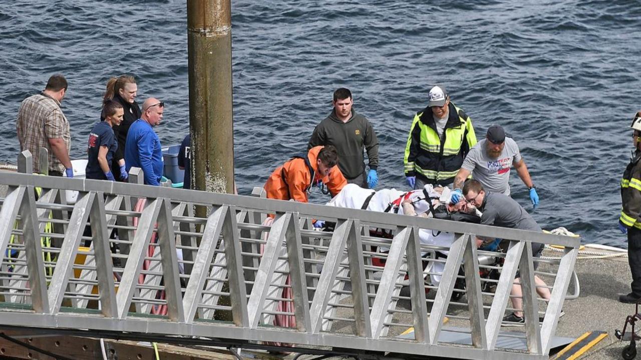Rescuers bring the injured to shore after the sea plane collision over Alaska. Picture: Dustin Safranek/Ketchikan Daily News via AP