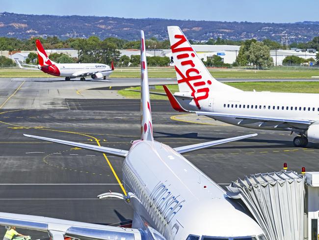 Adelaide, Australia. Planes from domestic air industry competitors and rivals Qantas and Virgin, coming and going from Adelaide airport.Escape 27 October 2024Kendall HillPhoto - Getty Images