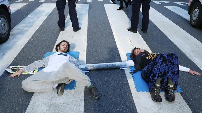 Eric Serge Herbert and Ebony Louise Mombaerts protesting government inaction on climate change by attaching themselves to the road in Post Office Square, Brisbane. Mombaerts pleaded guilty today to public nuisance today in the Brisbane Magistrates Court. Picture: Liam Kidston.