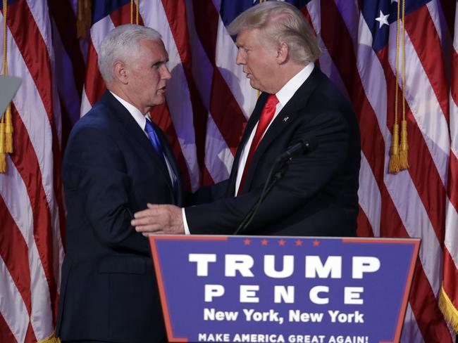 President-elect Donald Trump, right, shakes hands with Vice-President-elect Mike Pence during his election night rally. Picture: AP Photo/John Locher