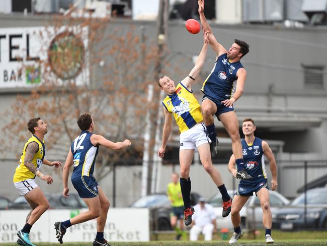 MPNFL ruckman Dylan Jones goes up against the NFNL’s Jordan Perry at Preston Oval on Saturday.