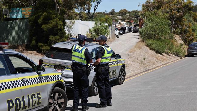 Police outside the entry to the Lonsdale property as its raided. NCA NewsWire / David Mariuz