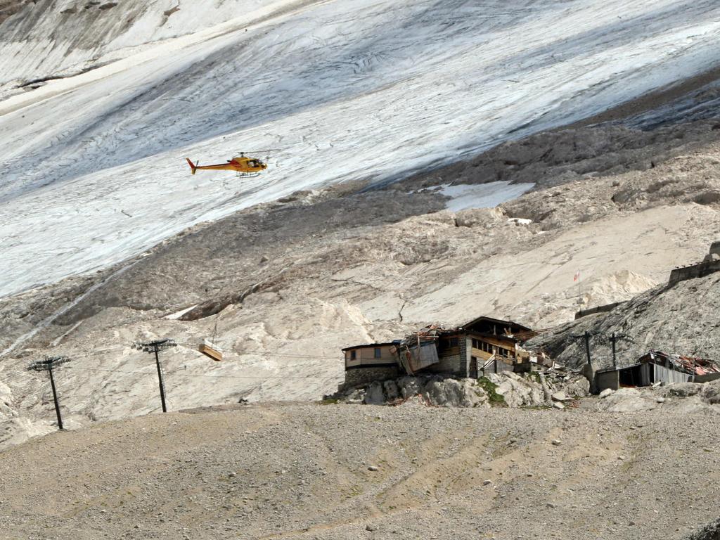 A helicopter carries tubes with remote sensors to monitor the Marmolada glacier. Picture: Pierre Teyssot/AFP