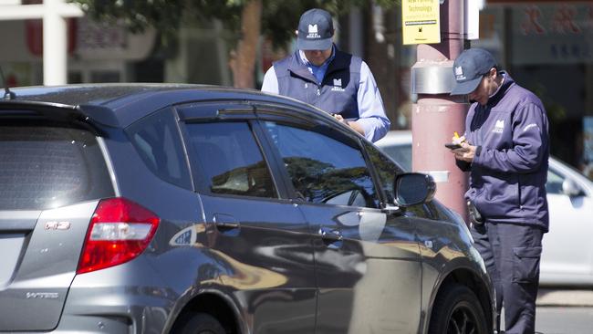 Monash Council parking inspectors dish out a fine on Kingsway, Glen Waverley. Picture: Nathan Dyer