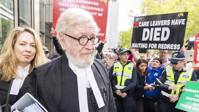 Pell’s lawyer Robert Richter is mobbed outside court. Picture: AAP Image/Daniel Pockett