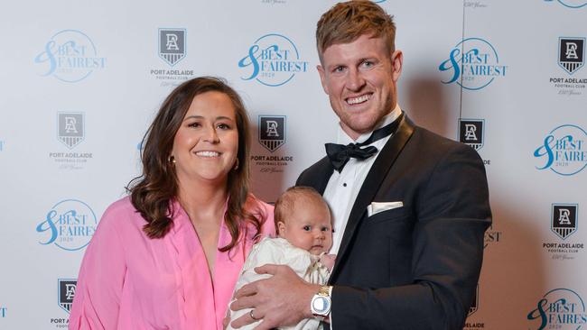 Power skipper Tom Jonas with wife Millie and baby Matilda on Thursday night. Picture: Brenton Edwards