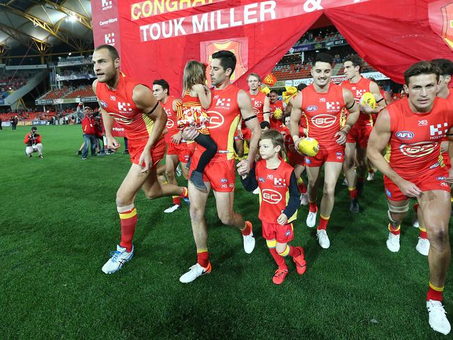 Michael Rischitelli of the Suns (centre) runs out with his kids for his final game during the round 23 AFL match between the Gold Coast Suns and the Greater Western Sydney Giants at Metricon Stadium on August 24, 2019 in Gold Coast, Australia. (Photo by Jono Searle/AFL Photos/via Getty Images)