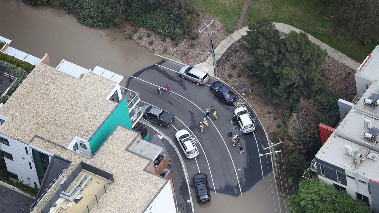 Motorist on Hobsons Road Kensington were surrounded by rising flood waters. Picture: David Caird.