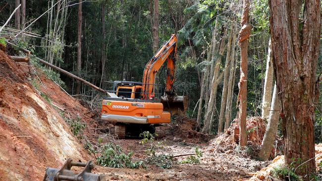 An excavator clears rubble and debris from a landslide near Main Arm Road in Upper Main Arm. Record rains and flash flooding caused a number of landslides near Mullumbimby earlier this month. Picture: Toby Zerna