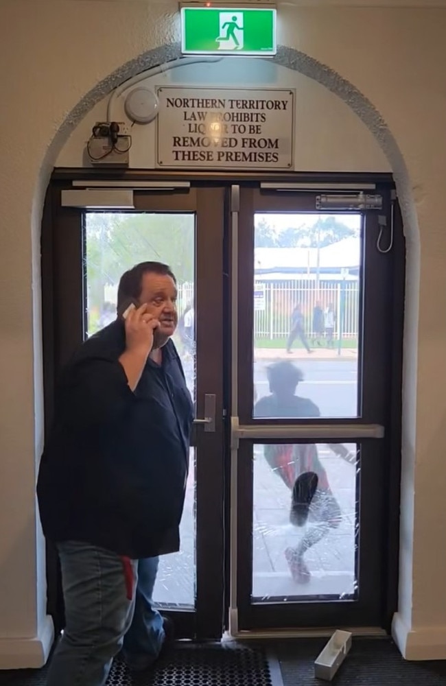 A person kicks in the door frame of a Alice Springs tavern during the riot. Picture: Supplied