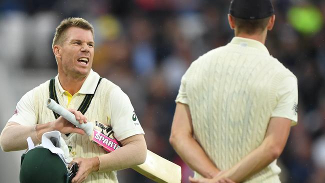 Australia batsman David Warner has a word with England bowler Chris Woakes as players go off for bad light during day one of the 3rd Ashes Test match between England and Australia. Picture: Stu Forster/Getty