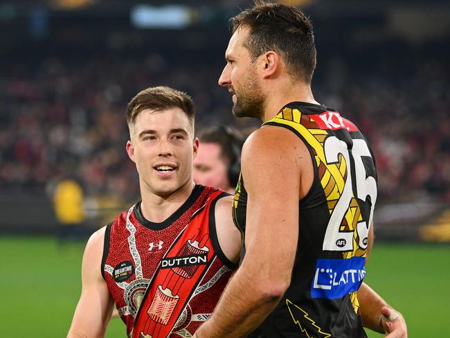 MELBOURNE, AUSTRALIA - MAY 25: Zach Merrett of the Bombers and Toby Nankervis of the Tigers embrace each other following the round 11 AFL match between Richmond Tigers and Essendon Bombers at Melbourne Cricket Ground, on May 25, 2024, in Melbourne, Australia. (Photo by Morgan Hancock/AFL Photos/via Getty Images)