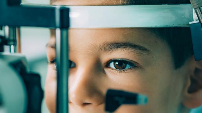 Eye Exam. Ophthalmologist examining boy's eyes with slit lamp Picture: Istock