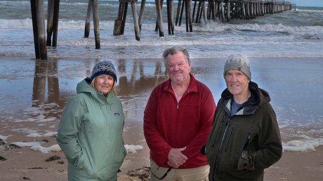 Locals Tracey Finch, Stephen Ellis, and John Belchamber, check out the damage. Picture: Dean Martin