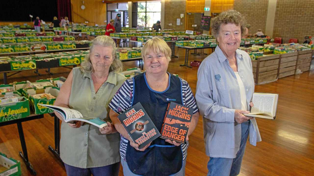 PAGE TURNER: Blue Care Book Sale Coordinator Val Kilah and volunteers Elsie Dallinger and Brenda Moor show off some of the books available at the Gatton Shire Hall. Picture: Dominic Elsome