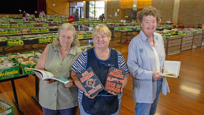 PAGE TURNER: Blue Care Book Sale Coordinator Val Kilah and volunteers Elsie Dallinger and Brenda Moor show off some of the books available at the Gatton Shire Hall. Picture: Dominic Elsome