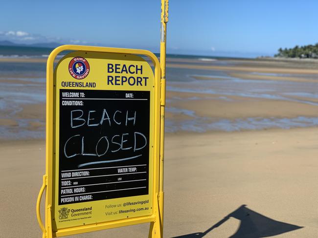 Flowers left at the base of a red flag at Eimeo Beach closed after 14-year-old boy Mark Angelo Ligmayo was stung by a box jellyfish on Saturday, February 26, 2022. He died at Mackay Base Hospital. Picture: Tara Miko