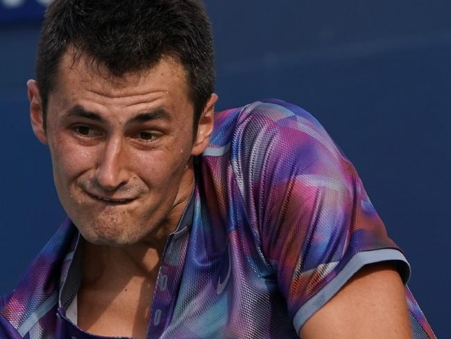 Australia's Bernard Tomic returns the ball to Luxemburg's Gilles Muller during their Men's Singles match at the 2017 US Open Tennis Tournament on August 28, 2017 in Flushing Meadows, New York. / AFP PHOTO / DON EMMERT