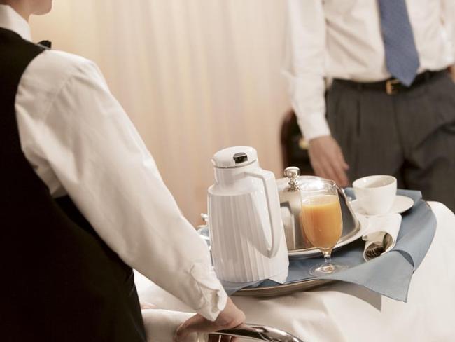 Businessman in hotel room receiving room service