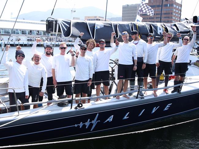 The Alive crew celebrates being the first Tasmanian yacht to arrive in Hobart in the 2018 Sydney to Hobart race. Picture: EDDIE SAFARIK