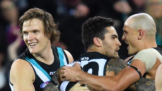 Jared Polec, Chad Wingard and Sam Powell-Pepper of the Power celebrate a goal in Showdown 44. Picture: David Mariuz/AAP