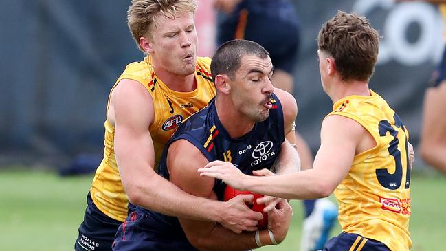 Taylor Walker tackled by Fischer McAsey. Picture: Sarah Reed