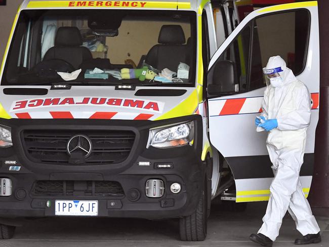 An ambulance is cleaned at the Royal Melbourne Hospital in Melbourne on October 9, 2021, as Victoria state recorded 1965 new Covid cases, its highest daily infection number since the start of the pandemic, putting more pressure on the state's struggling health system. (Photo by William WEST / AFP)