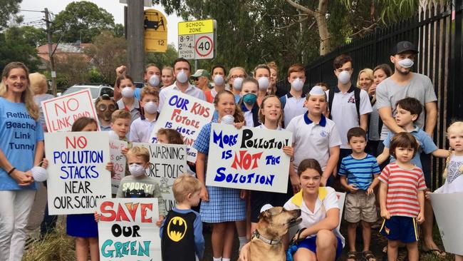 Schoolchildren and parents stage a dust mask protest, outside Balgowlah Boys High School, against the Beaches Link tunnel proposal. Picture: Manly Daily