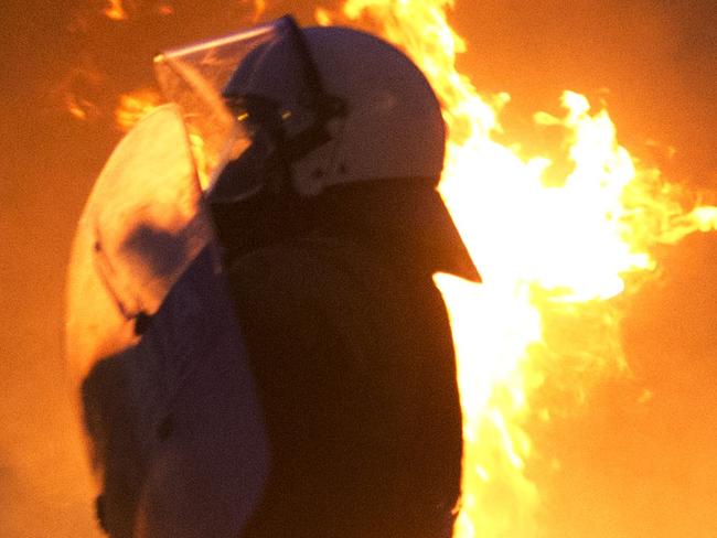 Riot policeman tries to avoid a petrol bomb thrown by anti-austerity protesters in Athens, Wednesday, July 15, 2015. Greece has a tentative rescue deal, but relief that it is not falling out of the euro is unlikely to last long: its economy has taken a huge hit. Months of political brinkmanship, uncertainty and bank closures have hurt companies and brought everyday business to a standstill. (AP Photo/Petros Giannakouris)